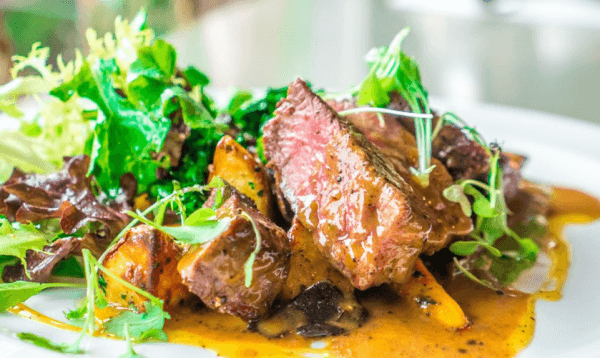 Seared beef with greens and roasted vegetables